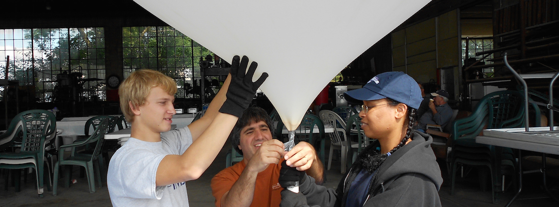 A group of Far Horizons participants launch a high-altitude balloon into the atmosphere.