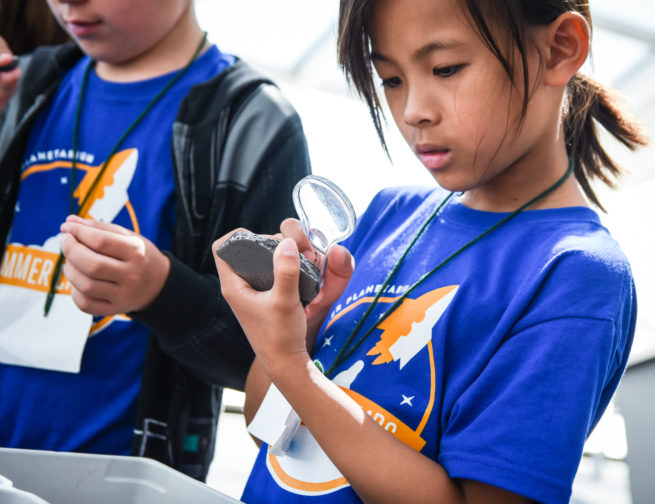Adler Summer Camp Participant Looking At Space Rock