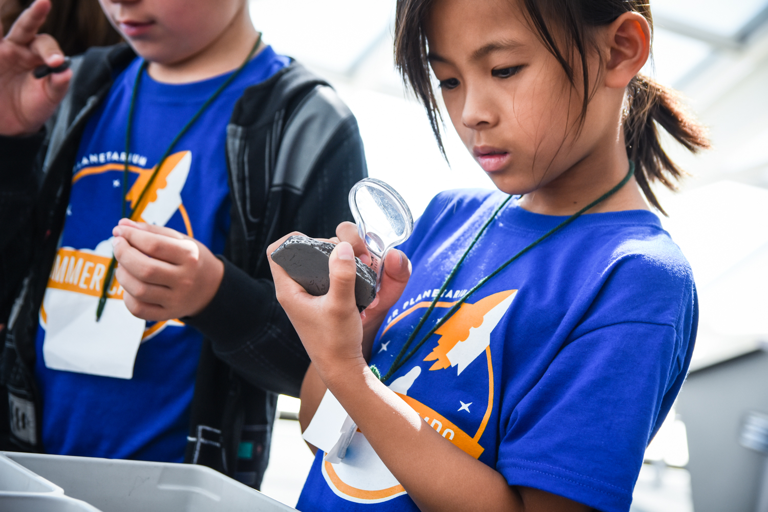 Adler Summer Camp Participant Looking At Space Rock