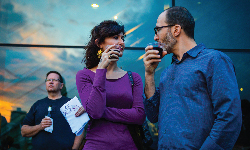 Two guests enjoying drinks out on the Adler's terrace.