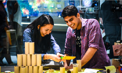 Two Adler guests smile while working together on a Community Design Lab project.