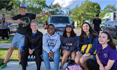 A group of Adler teens smile while at an Adler event.