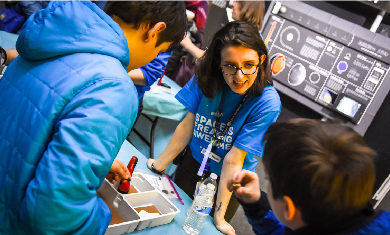 An Adler staff member engages in a discussion with a guest while at a pop-up booth.