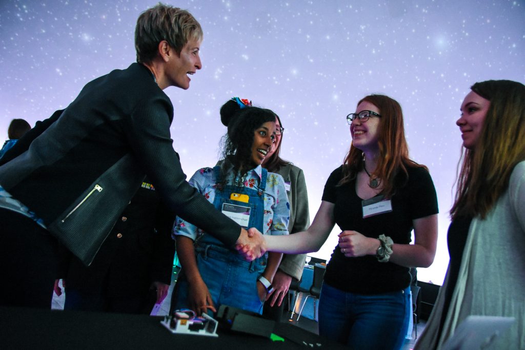 Dr. Whitson shakes hands with an Adler teen