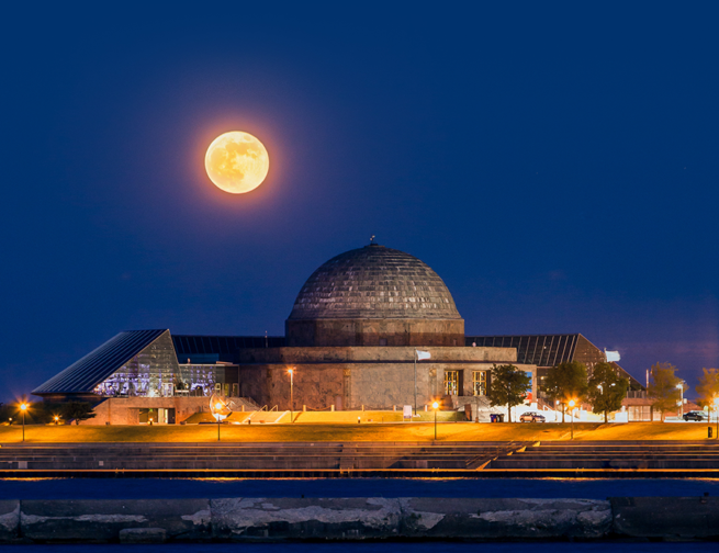 Moon rising over the Adler Planetarium
