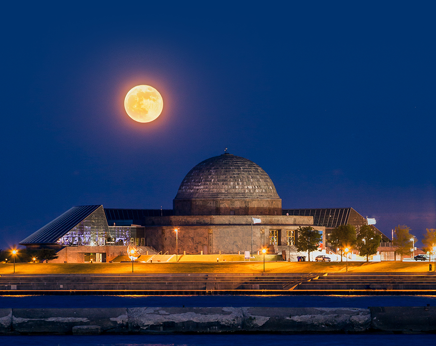 Moon rising over the Adler Planetarium