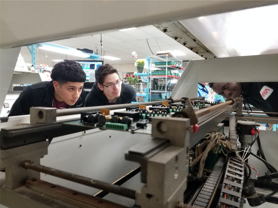 Adler Teens inspect machine in Far Horizons lab.