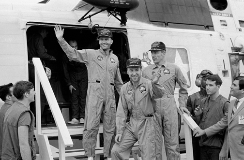 The crew of Apollo 13 land back on Earth.