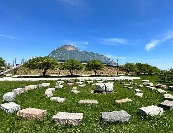 Americas’ Courtyard, a stone sculpture outside the Adler Planetarium in Chicago Illinois on a sunny day.