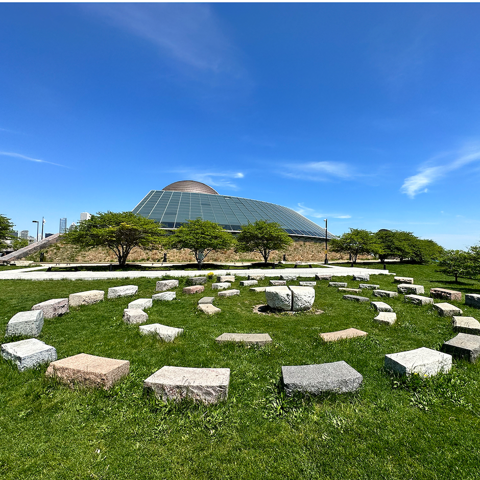 Americas’ Courtyard, a stone sculpture outside the Adler Planetarium in Chicago Illinois on a sunny day.