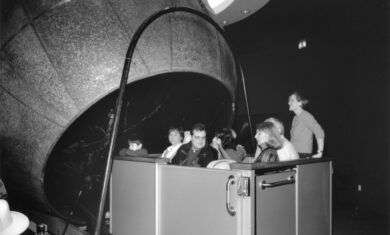 A full carload of visitors is pictured either going into or coming out of the Atwood Sphere.