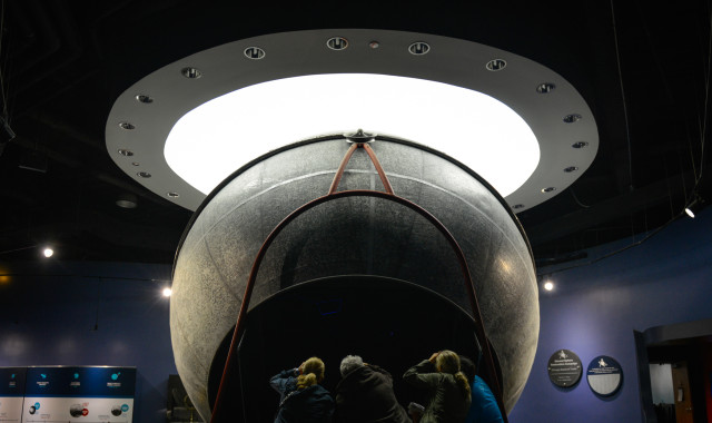 A group of Adler guests peer into the historic Atwood Sphere. 