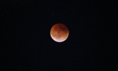 The full Moon is covered by a dark red shadow during a total lunar eclipse