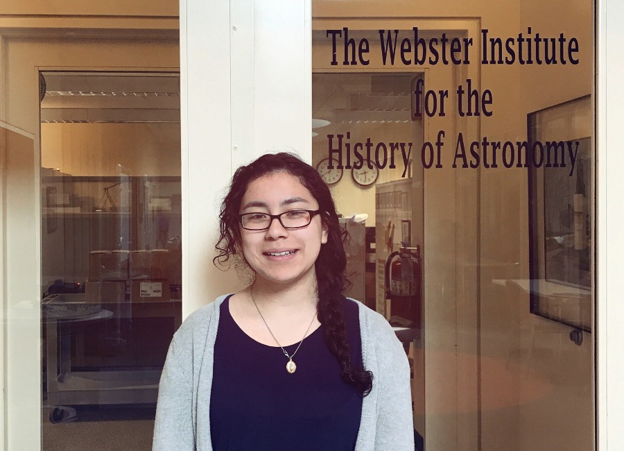 Headshot of Brenda, Adler Teen Collections Intern, standing in front of the History of Astronomy collections door