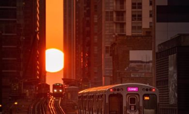 The Sun sets during Chicagohenge as a CTA train in Chicago, Illinois travels towards it. Image Credit: @cdats
