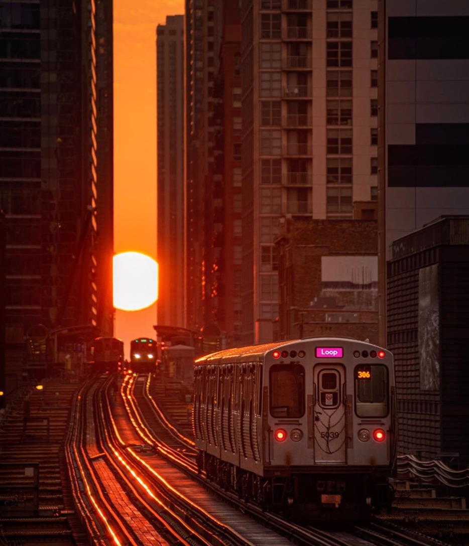 The Sun sets during Chicagohenge as a CTA train in Chicago, Illinois travels towards it. Image Credit: @cdats