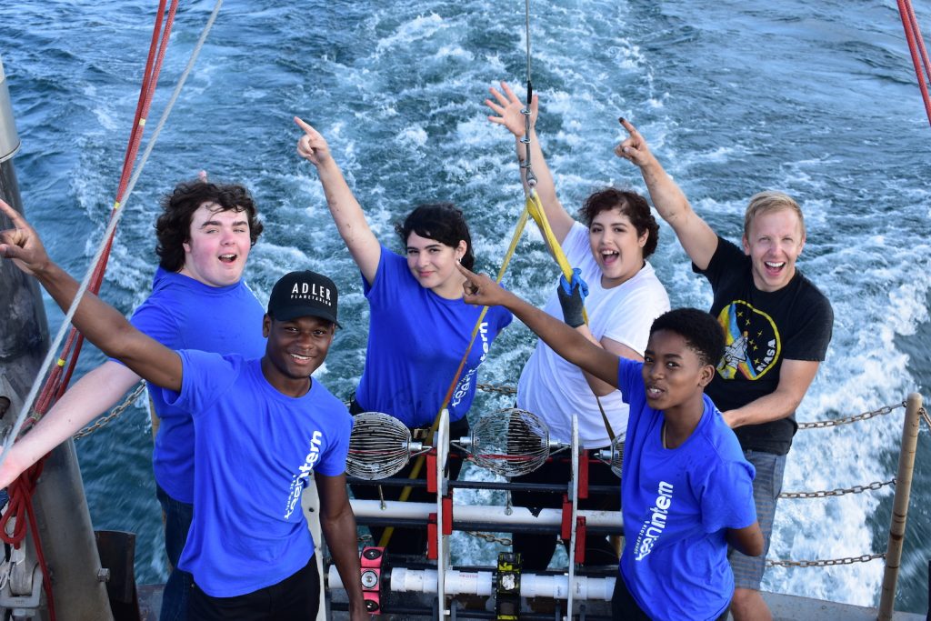 Adler Teens launching the underwater ROV sled into the lake.