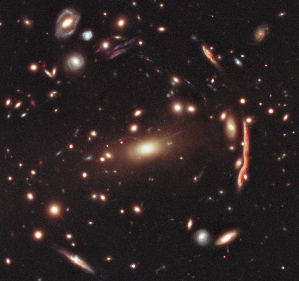 This image depicts a cluster of distorted galaxies. The distorted shapes in the cluster shown here are distant galaxies, from which the light is bent by the gravitational pull of dark matter within the cluster of galaxies.