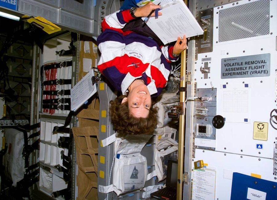 Dr. Ellen Ochoa floating upside down on the Shuttle