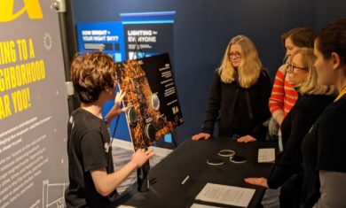 Adler Teen Stratonaut Duncan A. Yuen presenting the team's findings about light pollution from the trip to Little Red Schoolhouse at an Adler Planetarium event.