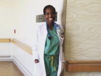A smiling Choumika poses in her hospital scrubs.