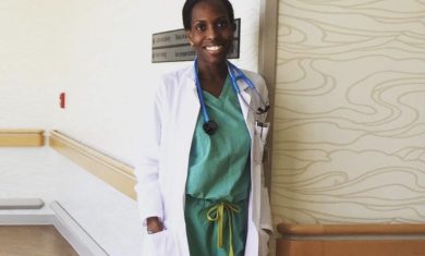 A smiling Choumika poses in her hospital scrubs.