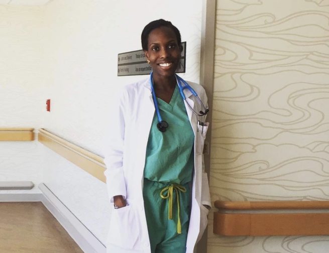A smiling Choumika poses in her hospital scrubs.