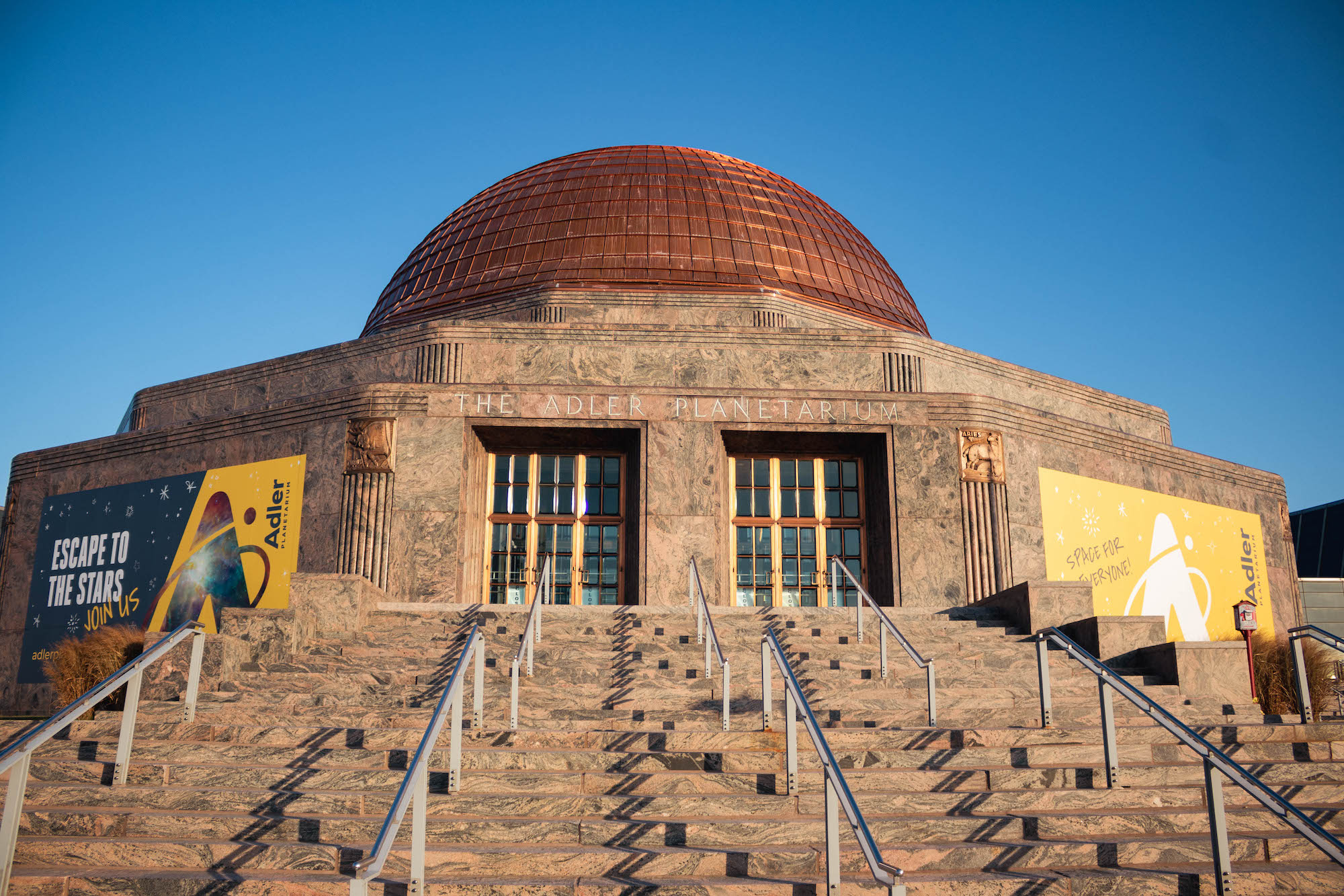 Exterior shot of Adler Planetarium main entrance with new copper dome. 