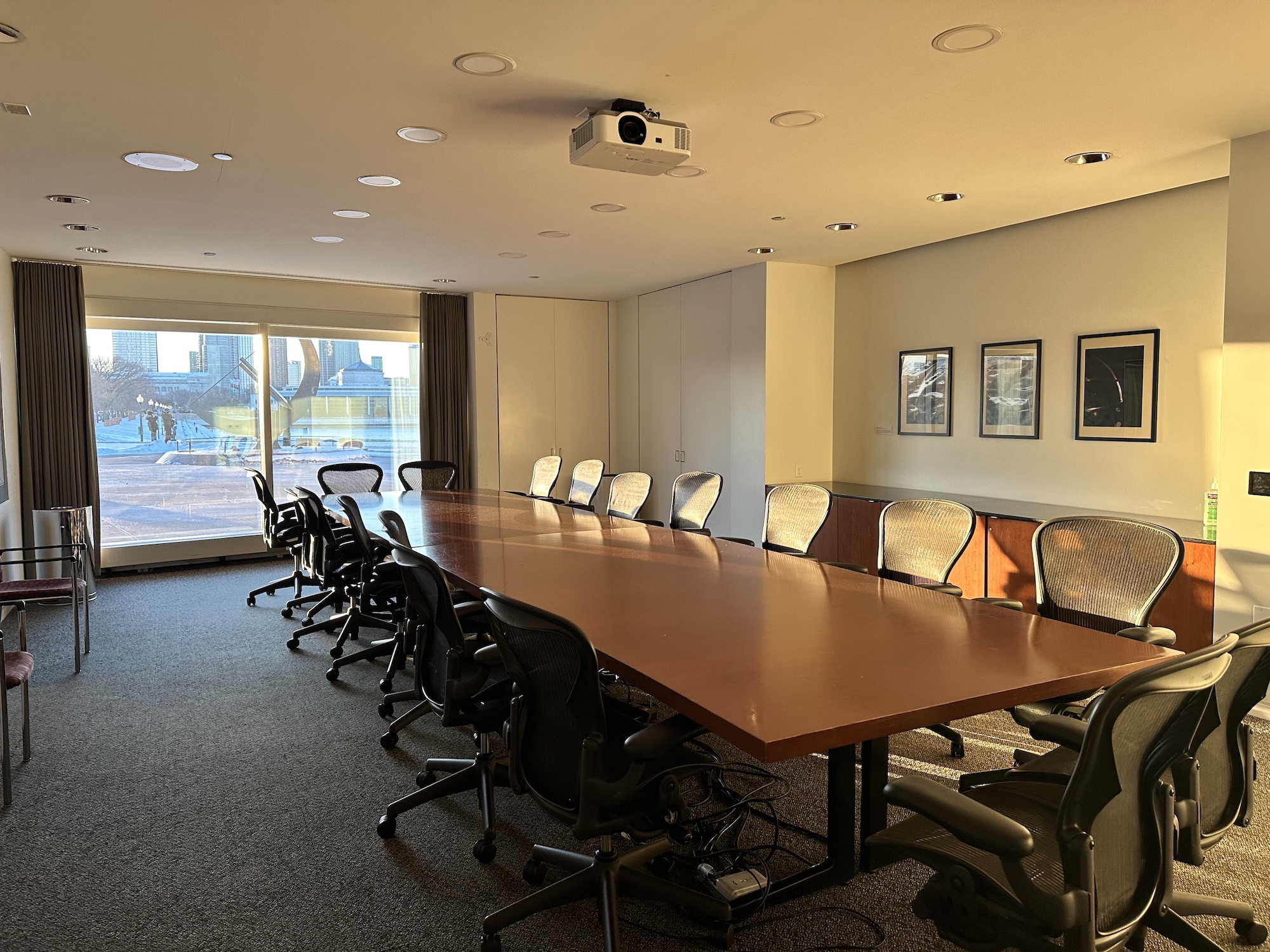 Photo of the boardroom facing the window that looks out over the sundial plaza. Sunlight streams in through the window.