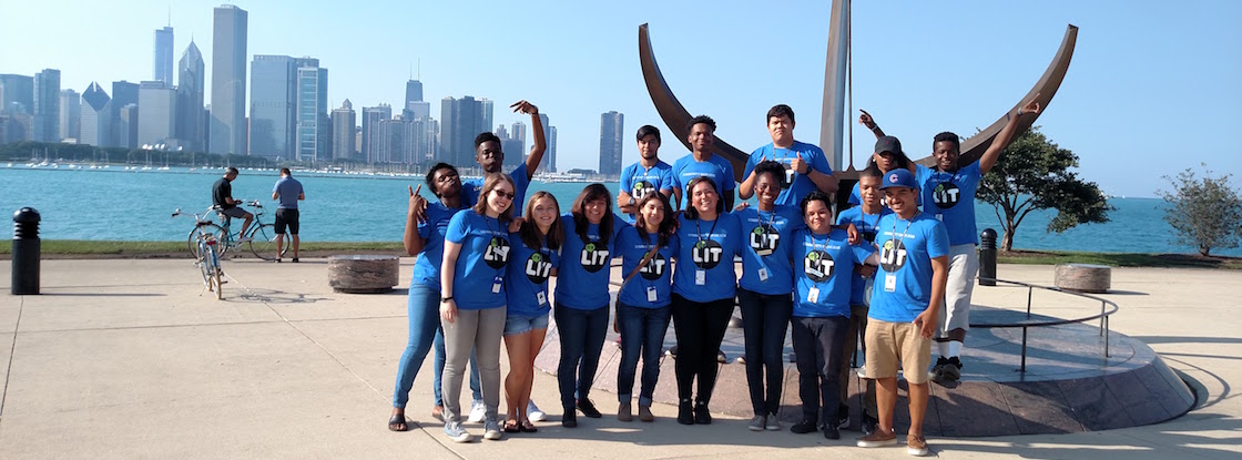 A group of Adler Teens posing outside of the Adler and in front of the Chicago skyline.