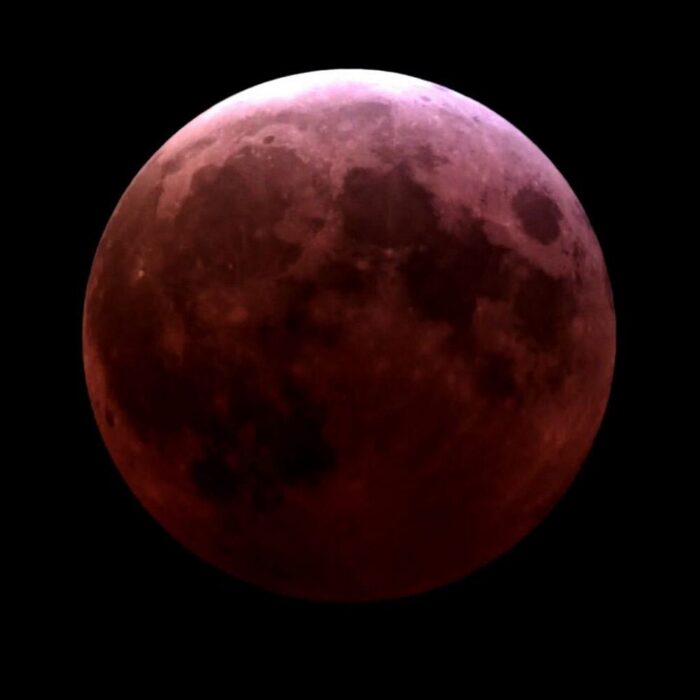 Image Caption: The March 13-14, 2025 lunar eclipse at totality. The full Moon appears to be a dark brick red as the Earth’s shadow covers it. Image credit: Adler Planetarium