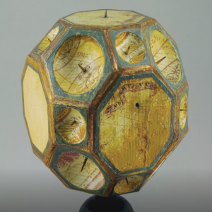 A 16th century, twenty-six-faced polyhedral sundial carved of wood.