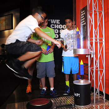 Kids jumping on a stomp rocket.