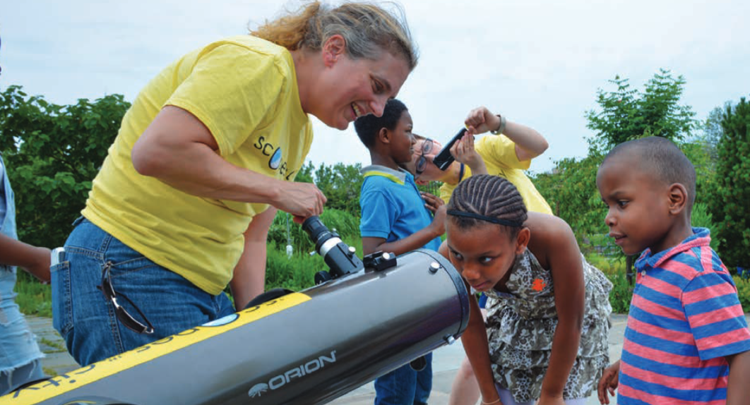 Michelle Nichols helping young skywatchers observe the sky at a 'Scopes in the City event.