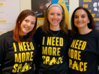 Staff members of the Adler Planetarium marketing team posing with newly branded Adler sweatshirts in January 2020.