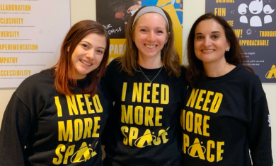 Staff members of the Adler Planetarium marketing team posing with newly branded Adler sweatshirts in January 2020.