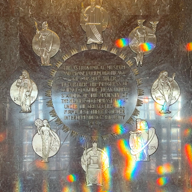 Dedication plaque in the Rainbow Lobby with real rainbows illuminating the plaque.