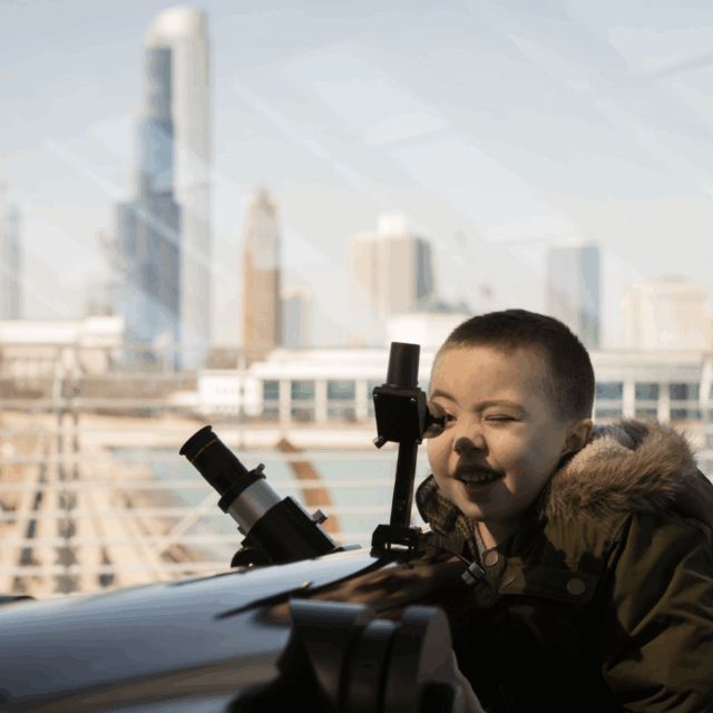 Child looking out telescope