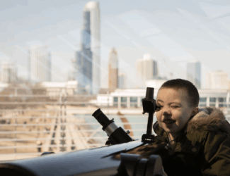 Child looking out telescope