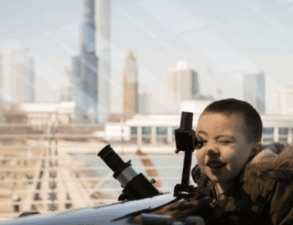 Child looking out telescope