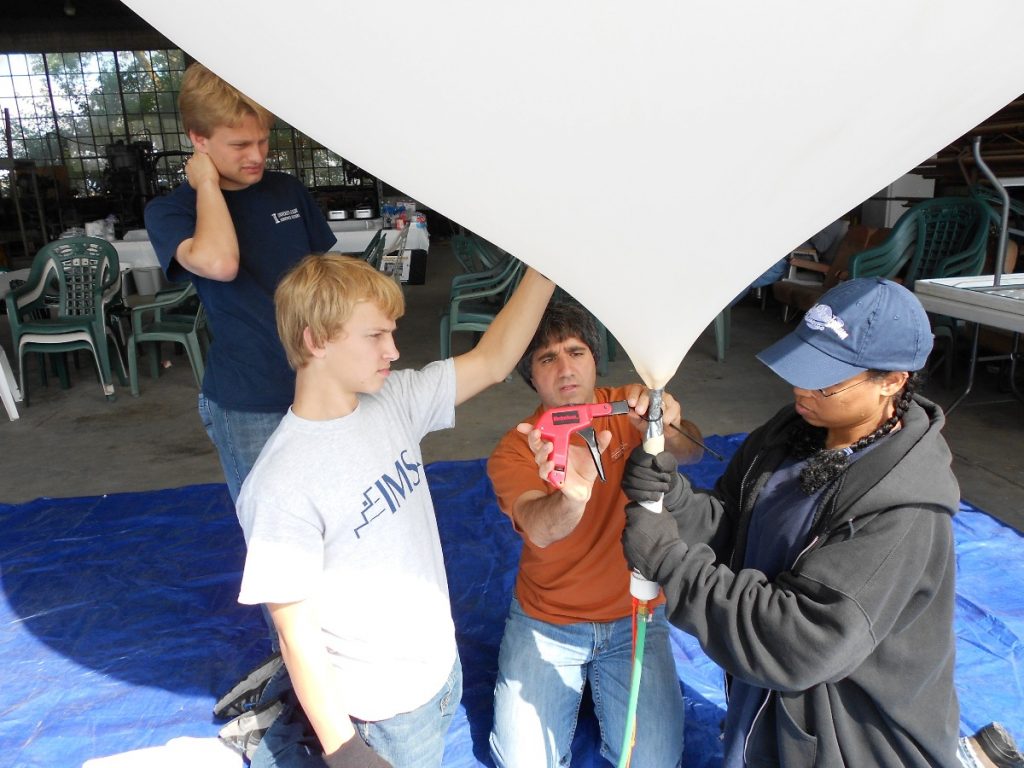 Spencer Gore (left background, blue shirt) participating in a Far Horizons balloon launch on September 4, 2011.