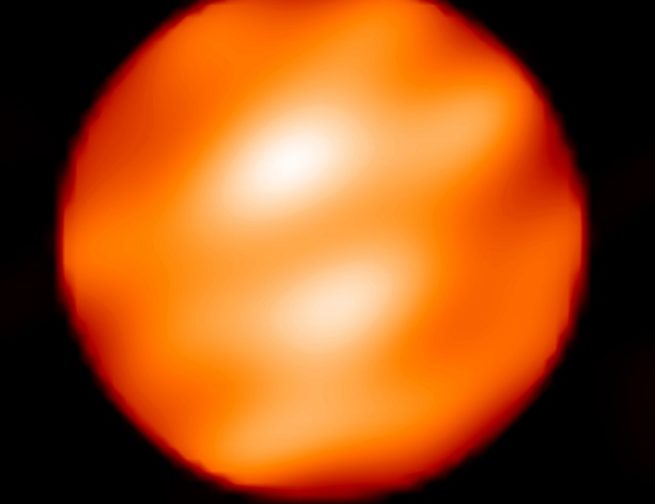 The spotty surface of Betelgeuse shown with two, large, bright, star spots. The spots potentially represent enormous convective cells rising from below the supergiant's surface. They are bright because they're hotter than the rest of the surface, but both spots and surface are cooler than the Sun.