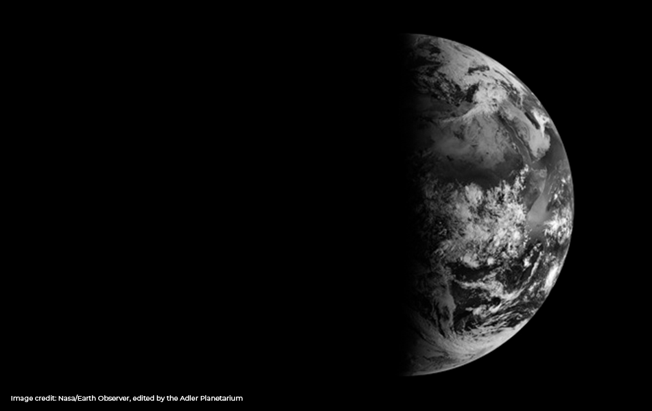 Black and white image of the Earth, as seen from space, on the spring equinox in 2013. Image Credit: Nasa/ Earth Observer, edited by the Adler Planetarium