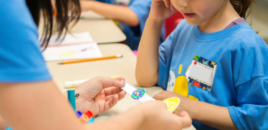 Young summer camper engaging in a hands-on activity.