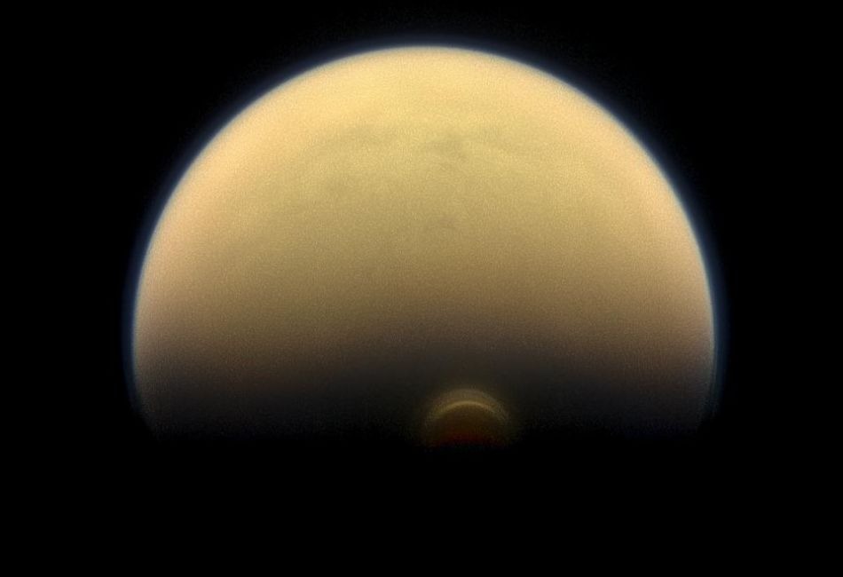 Slipping into shadow, the south polar vortex at Saturn's moon Titan still stands out against the orange and blue haze layers that are characteristic of Titan's atmosphere.