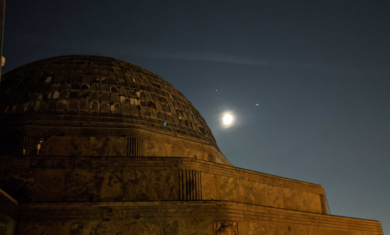The Adler Planetarium with the Moon, Jupiter and Saturn in the background.