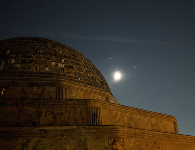 The Adler Planetarium with the Moon, Jupiter and Saturn in the background.