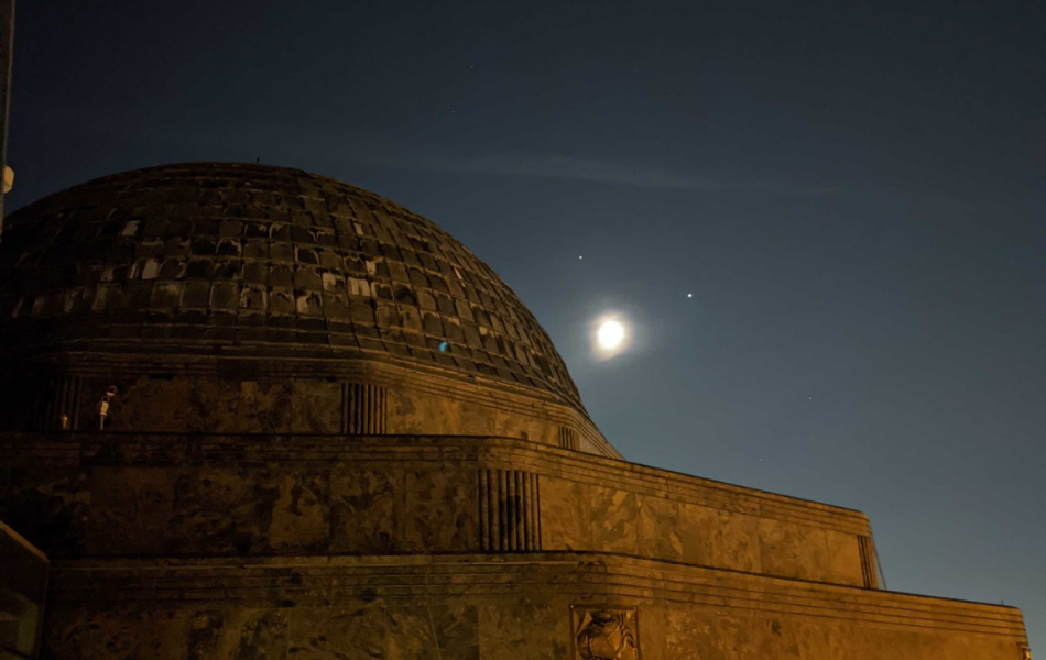 The Adler Planetarium with the Moon, Jupiter and Saturn in the background.