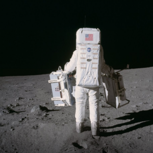 Buzz Aldrin deploying Apollo 11 instruments on the Moon, his back facing the camera.