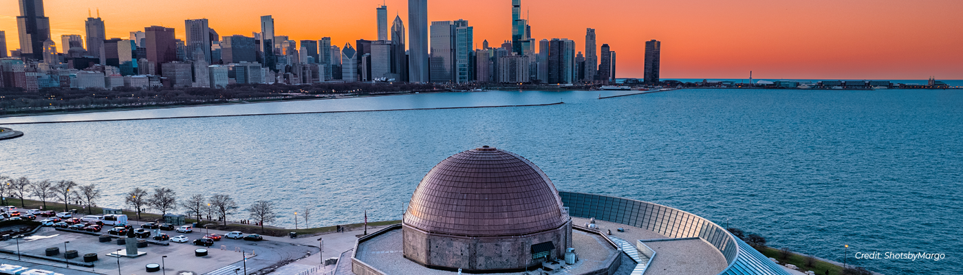 Aerial shot of the Adler Planetarium with the new copper roof at sunset. Shot taken from the south looking north toward the skyline.